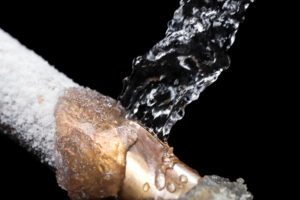 A frozen pipe with water being poured on it