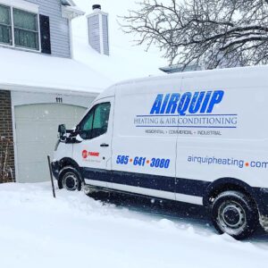 An Airquip work van parked in a snowy driveway